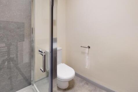 A clean, well-maintained bathroom featuring a t...