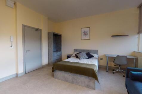 Bright and modern bedroom featuring a comfortab...