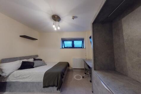 Cozy double bedroom featuring a comfortable bed...