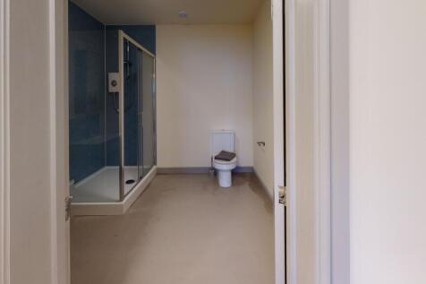 A spacious bathroom featuring a walk-in shower ...