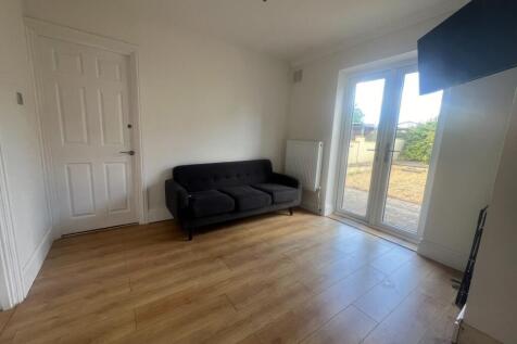 A bright and tidy living room featuring light w...