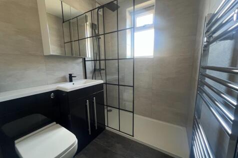 Modern bathroom featuring sleek black cabinetry...