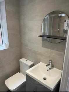 A modern and well-maintained single toilet feat...