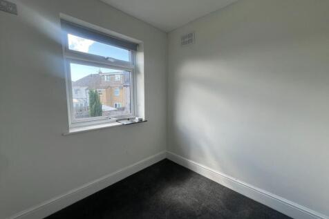 A clean and well-maintained small room with a w...