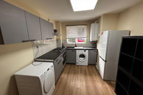 A modern, well-maintained kitchen featuring sle...