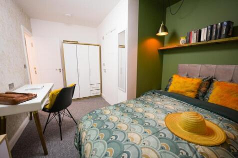 A bright and stylish bedroom featuring a comfor...
