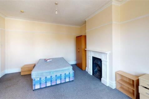 A spacious double bedroom featuring a comfortab...