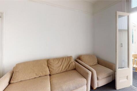 A cozy living room featuring a comfortable beig...
