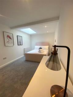 A bright and modern master bedroom featuring a ...