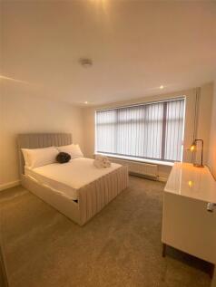 Bright and neatly arranged double bedroom featu...