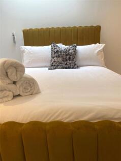 A cozy and well-kept double bedroom featuring a...