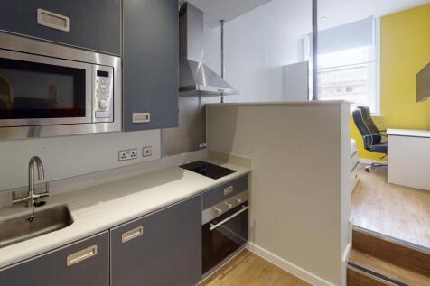 Modern kitchen area with sleek grey cabinetry, ...