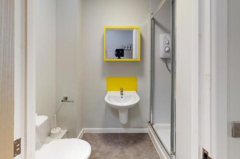 A modern bathroom featuring a clean white toile...