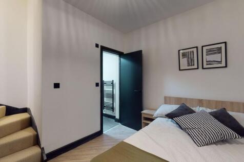 A bright and modern master bedroom featuring a ...