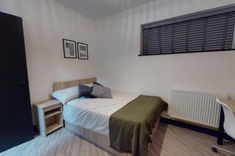 A cozy bedroom featuring a double bed with pill...
