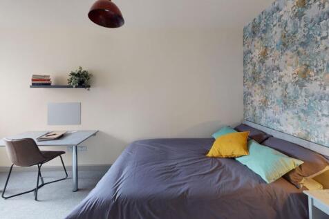 A modern bedroom featuring a comfortable bed wi...