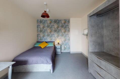 A bright and welcoming bedroom featuring a cozy...