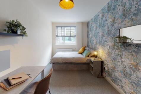 Bright and stylish bedroom featuring a comforta...