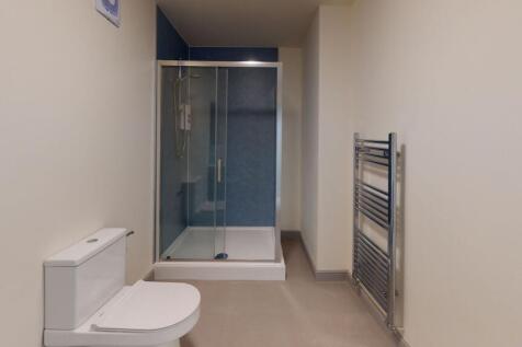 Modern bathroom featuring a sleek toilet, a spa...
