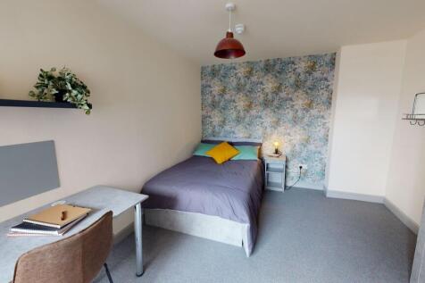 Bright and modern bedroom featuring a cozy doub...