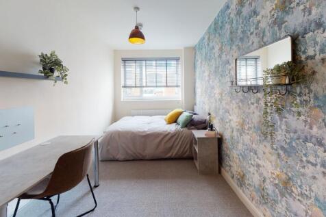 Bright and welcoming bedroom featuring a comfor...