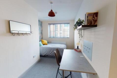 A bright, well-maintained master bedroom featur...