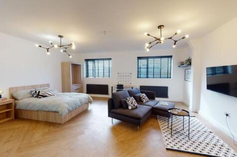 Modern and spacious living area featuring minim...