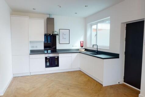 Modern, tidy kitchen with ample natural light, ...