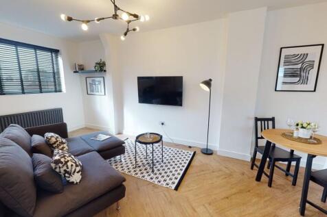 Bright and modern living room with stylish blac...