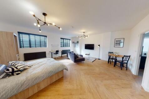 Spacious and modern living room featuring ample...