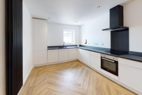 Modern and sleek kitchen with ample counter spa...