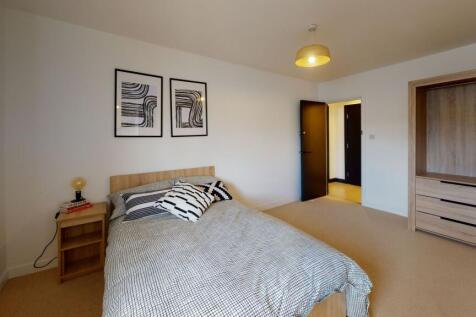 A spacious, well-maintained master bedroom feat...