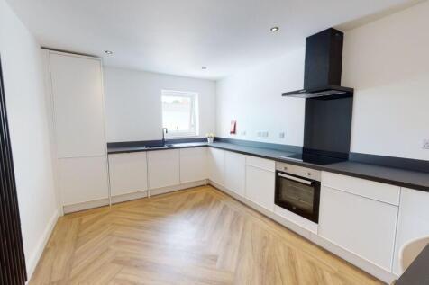 Modern, bright kitchen with sleek white cabinet...