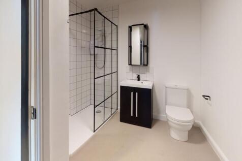 Modern bathroom featuring a walk-in shower with...