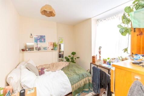 A cozy bedroom featuring a comfortable bed, a w...
