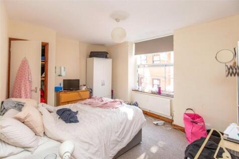 A spacious and bright double bedroom featuring ...