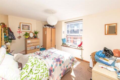 A bright and welcoming bedroom featuring a doub...