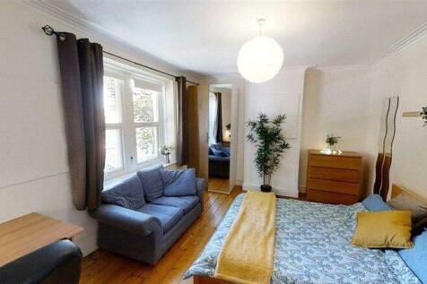Bright and welcoming master bedroom featuring a...