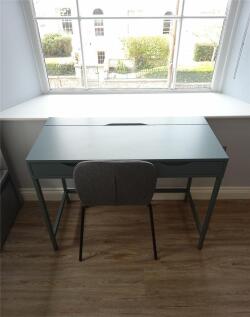 A bright and tidy communal workspace featuring ...