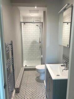 A modern bathroom featuring a walk-in shower wi...