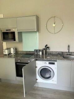 Modern kitchen with integrated appliances inclu...