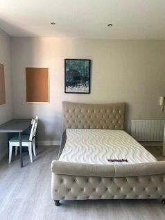 Bright and neatly arranged double bedroom featu...