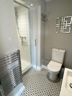 A modern bathroom featuring a walk-in shower wi...