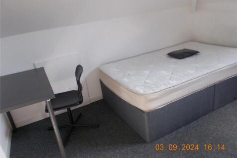 A neat and simple single bedroom featuring a ma...