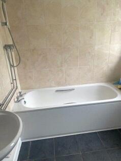 A clean and functional bathroom featuring a ful...