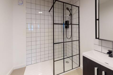 Modern bathroom featuring a sleek shower with w...