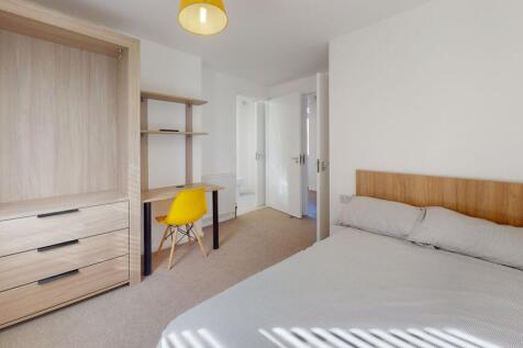 Bright and welcoming double bedroom featuring a...