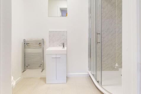 A clean and modern bathroom featuring a spaciou...