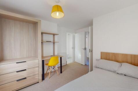 A bright and well-maintained master bedroom fea...