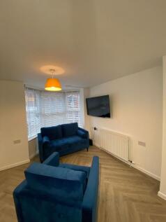 Modern living room featuring a comfortable blue...